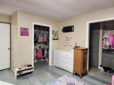 bedroom with a textured ceiling and a closet