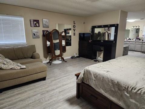 bedroom featuring wood-type flooring and a textured ceiling