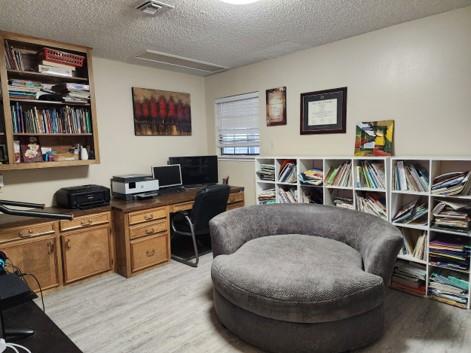 office with light wood-type flooring and a textured ceiling