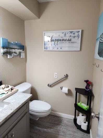 bathroom featuring hardwood / wood-style flooring, vanity, and toilet