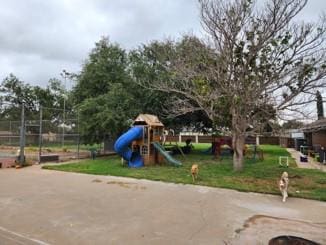 view of playground with a lawn