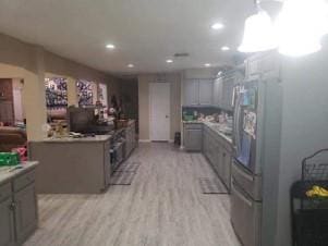 kitchen featuring gray cabinetry and light hardwood / wood-style floors