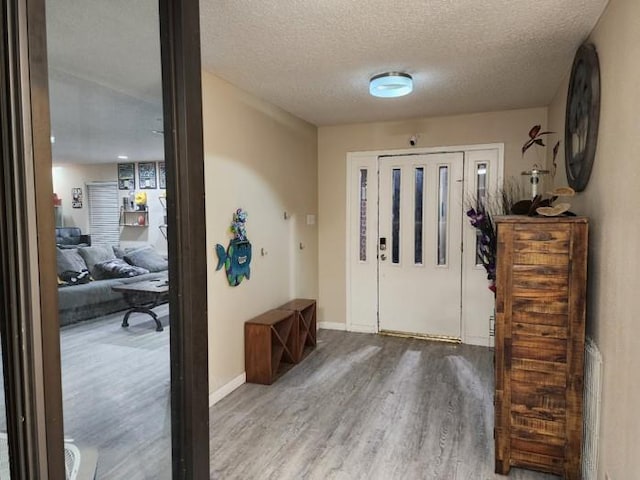 foyer with hardwood / wood-style floors and a textured ceiling