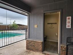 exterior space featuring a fenced in pool and a patio