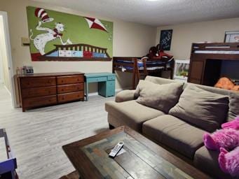 living room with light hardwood / wood-style flooring and a textured ceiling