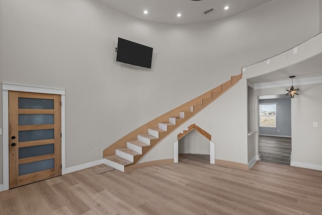 interior space with visible vents, baseboards, wood finished floors, stairs, and recessed lighting