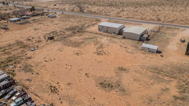 birds eye view of property featuring view of desert and a rural view