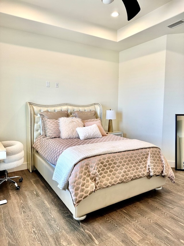 bedroom featuring recessed lighting, wood finished floors, visible vents, and baseboards