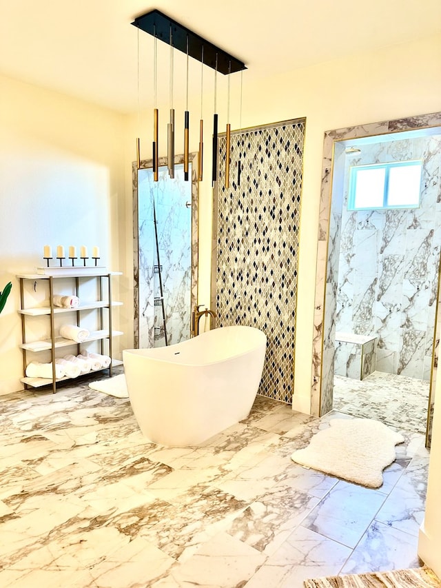 full bathroom with a freestanding tub, marble finish floor, and a marble finish shower