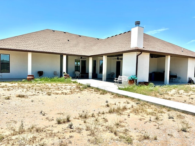 rear view of property featuring stucco siding, a patio area, roof with shingles, and ceiling fan