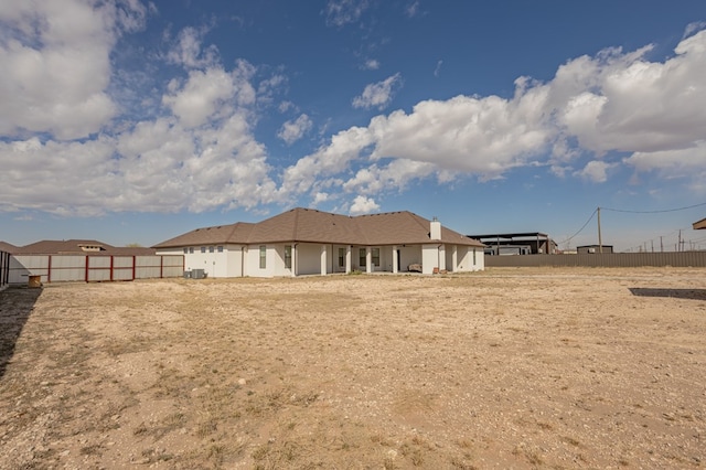 back of property with fence