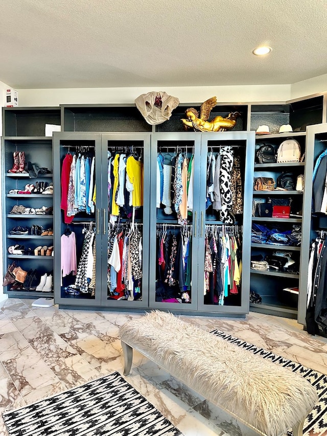 spacious closet featuring marble finish floor