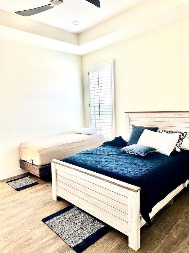 bedroom with ceiling fan and wood finished floors