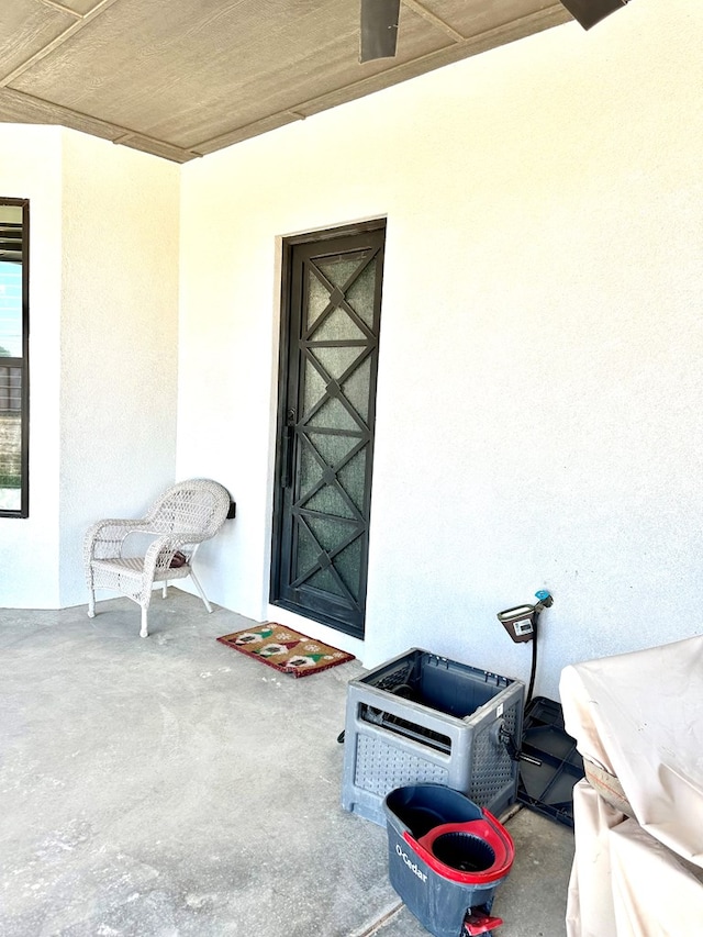 property entrance with stucco siding