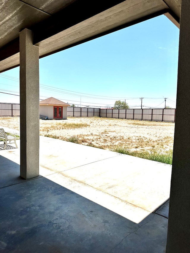 view of patio with an outbuilding and a fenced backyard