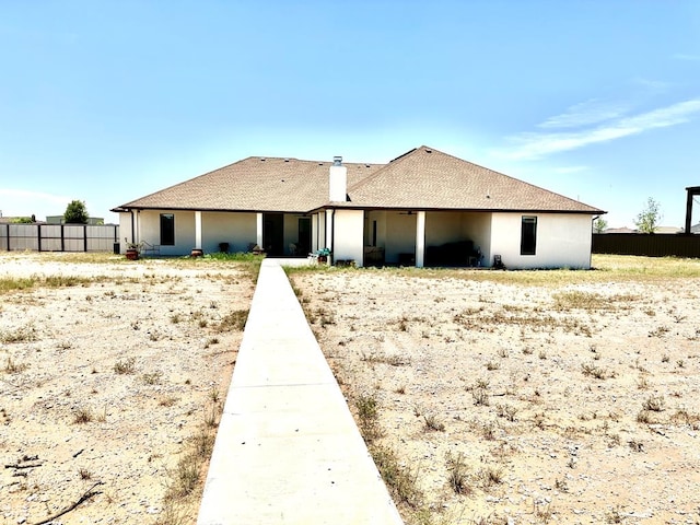 view of front of property featuring fence and a chimney