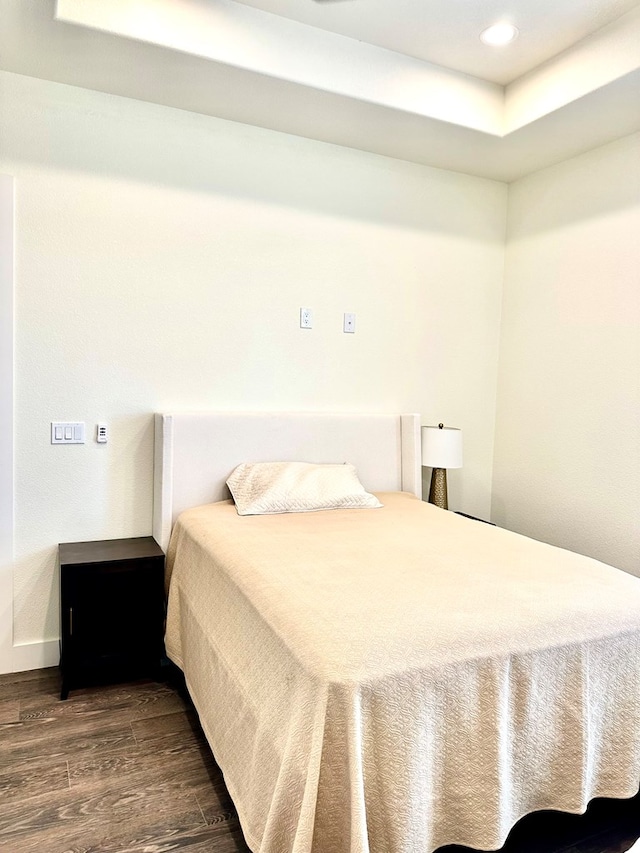 bedroom with recessed lighting and wood finished floors