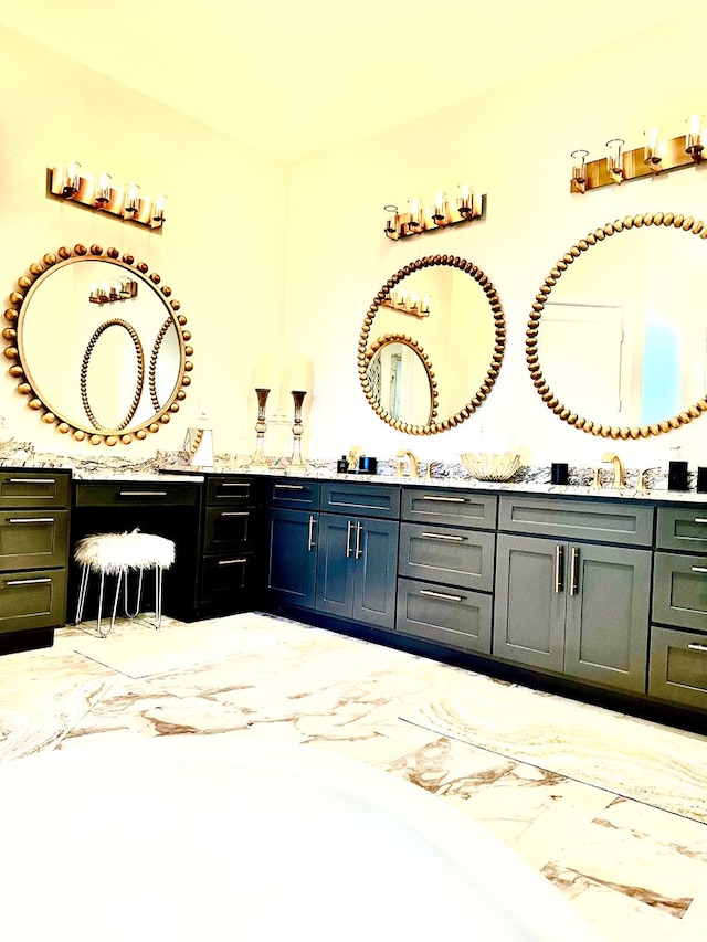 full bath featuring double vanity and marble finish floor