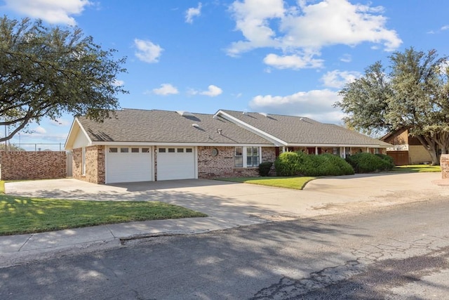 ranch-style house with a garage and a front lawn