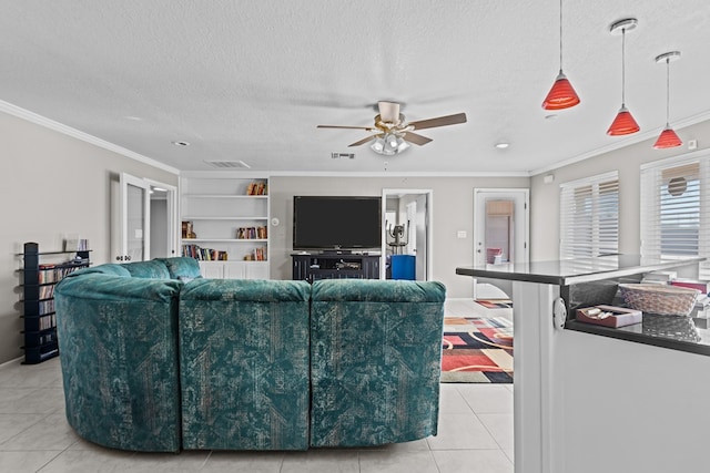 living room featuring crown molding, built in features, a textured ceiling, and light tile patterned floors