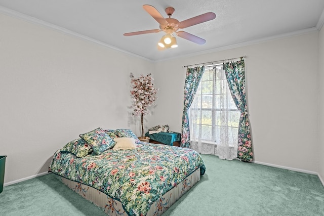 carpeted bedroom featuring ceiling fan and crown molding