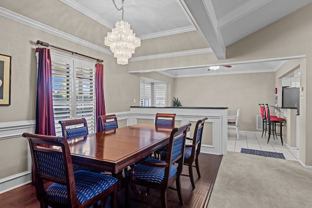 tiled dining space featuring ceiling fan and crown molding