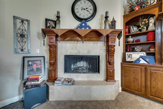 living room with carpet floors and a tile fireplace