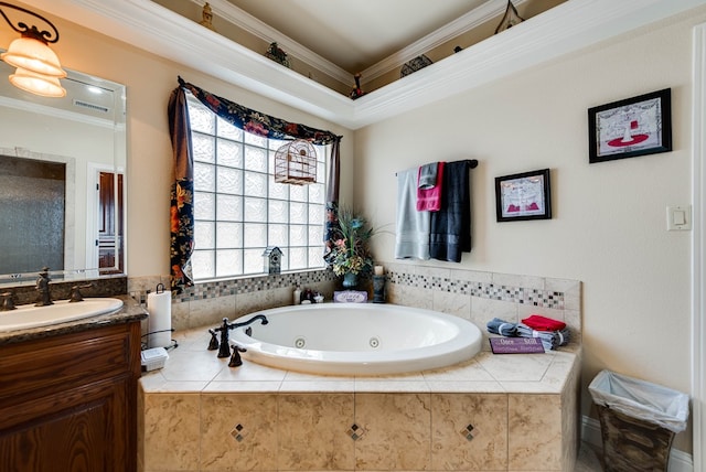 bathroom with tiled bath, crown molding, and vanity