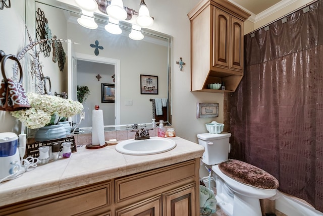 bathroom with vanity, toilet, and ornamental molding