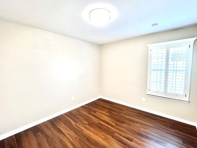 empty room featuring dark hardwood / wood-style floors