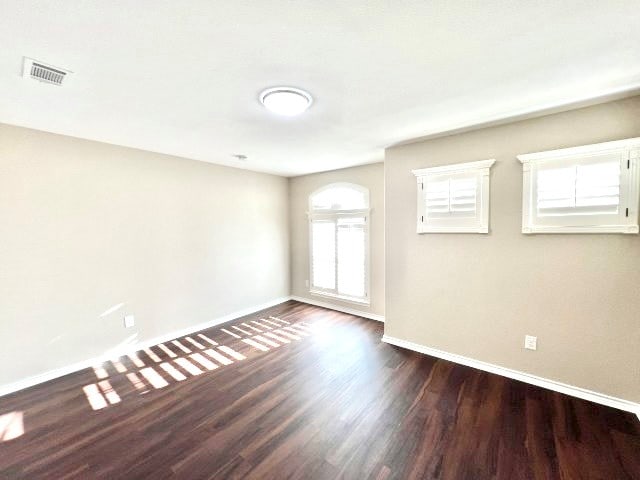 empty room featuring dark wood-type flooring