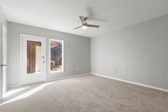 unfurnished room featuring a textured ceiling, ceiling fan, and light colored carpet