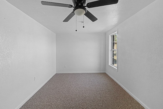 empty room with ceiling fan, carpet flooring, and a textured ceiling