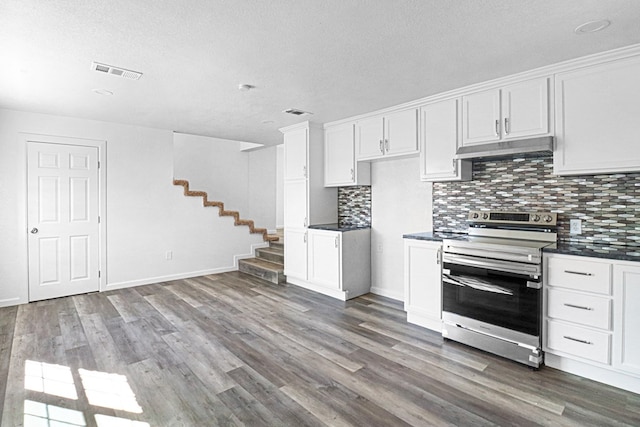 kitchen featuring tasteful backsplash, stainless steel electric stove, dark hardwood / wood-style flooring, and white cabinets