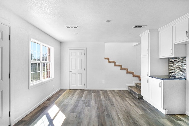 interior space featuring dark hardwood / wood-style floors and a textured ceiling