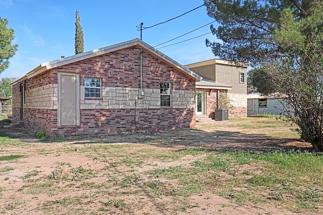 rear view of property featuring central air condition unit