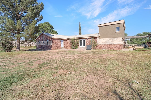 exterior space with cooling unit and a yard