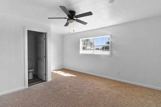 unfurnished bedroom with carpet floors, connected bathroom, and ceiling fan