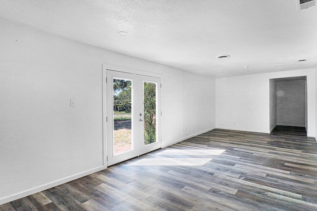 unfurnished room featuring dark hardwood / wood-style flooring and french doors