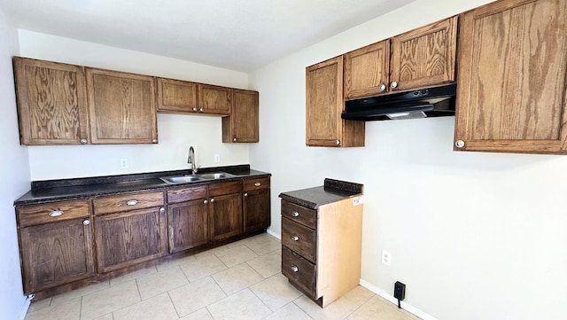 kitchen featuring light tile patterned floors and sink