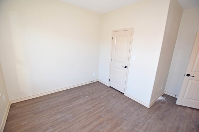 spare room with wood-type flooring