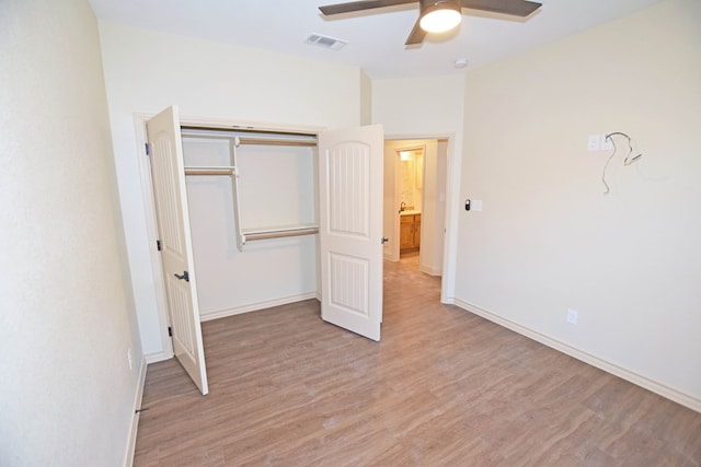 unfurnished bedroom with ceiling fan, light hardwood / wood-style floors, and a closet