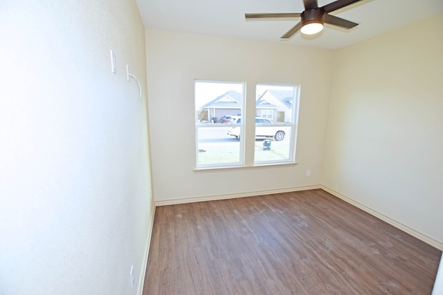 unfurnished room with hardwood / wood-style floors and ceiling fan