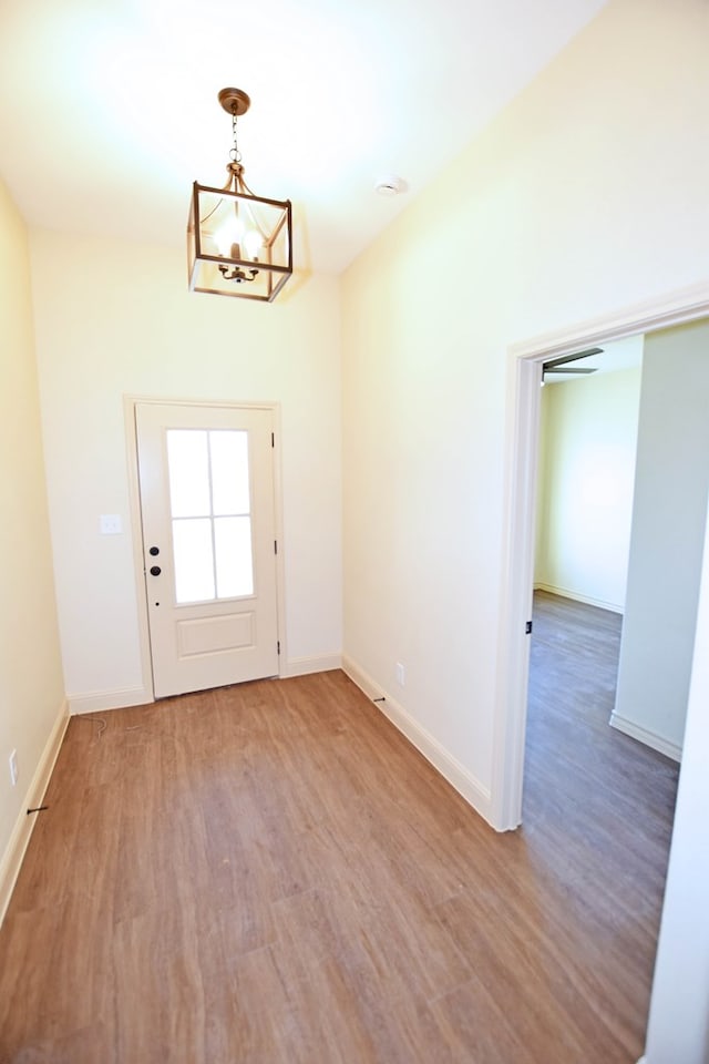 doorway featuring hardwood / wood-style flooring and an inviting chandelier