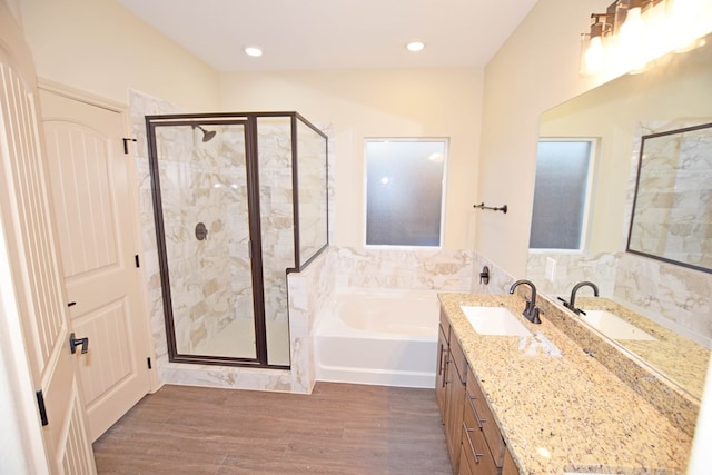 bathroom featuring wood-type flooring, vanity, and independent shower and bath