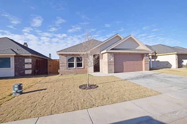 single story home featuring a front yard and a garage