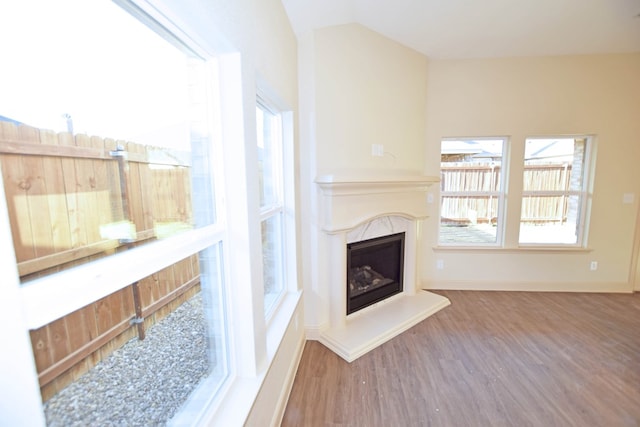 living room featuring wood-type flooring and a high end fireplace