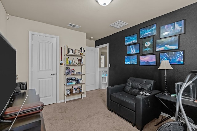 sitting room with visible vents and carpet flooring