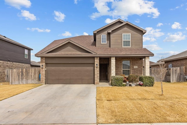 view of front of house with an attached garage, concrete driveway, a front yard, and fence