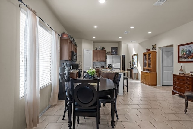 dining area featuring light tile patterned flooring, recessed lighting, and visible vents